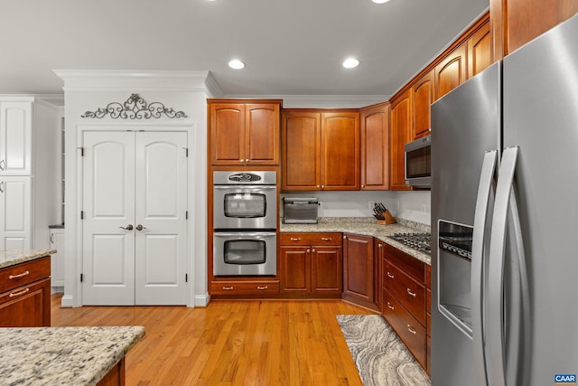 83 Mossy Creek Ct, Zion Crossroads, VA 22942 - kitchen with appliances with stainless steel finishes, light wood-type flooring, light stone counters, recessed lighting, and brown cabinetry