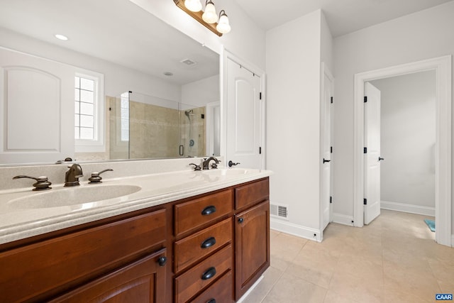 83 Mossy Creek Ct, Zion Crossroads, VA 22942 - bathroom featuring a shower stall, double vanity, tile patterned flooring, and baseboards