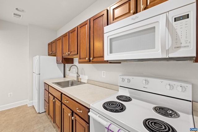 83 Mossy Creek Ct, Zion Crossroads, VA 22942 - kitchen featuring white appliances, brown cabinets, a sink, baseboards, and light countertops