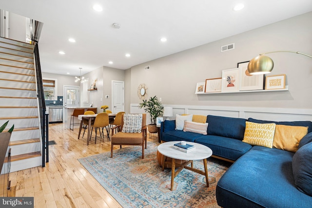 2409 S Watts St, Philadelphia, PA 19148 - living area with stairway, light wood-style flooring, recessed lighting, and a chandelier