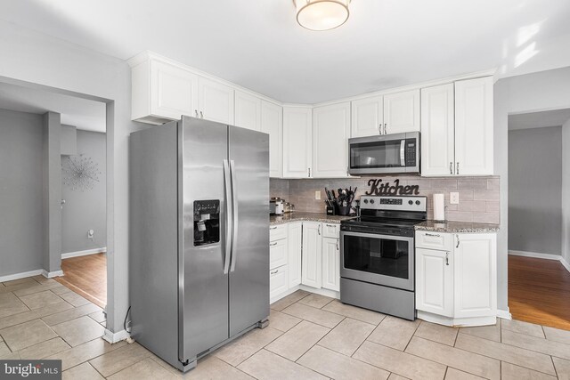 521 Rhode Island Ave, Cherry Hill, NJ 08002 - kitchen featuring appliances with stainless steel finishes, tasteful backsplash, white cabinets, and light stone countertops