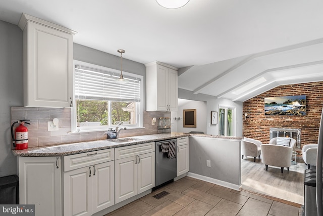 521 Rhode Island Ave, Cherry Hill, NJ 08002 - kitchen with stainless steel dishwasher, a sink, vaulted ceiling, tasteful backsplash, and white cabinetry