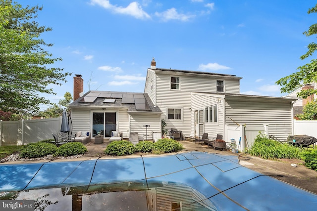 521 Rhode Island Ave, Cherry Hill, NJ 08002 - rear view of property with roof mounted solar panels, an outdoor hangout area, a patio area, and a chimney