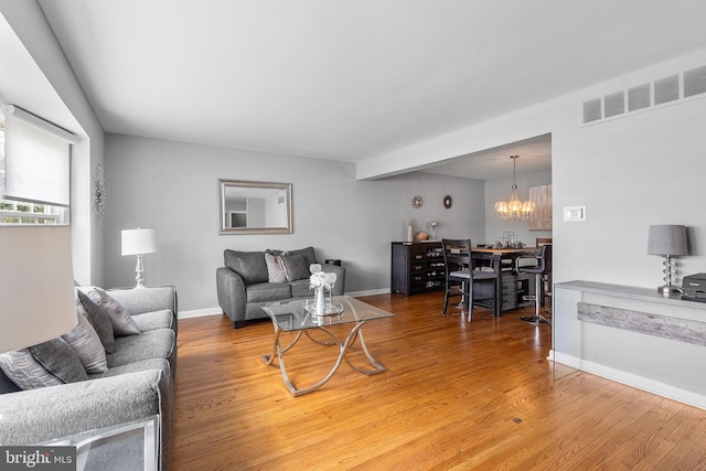 521 Rhode Island Ave, Cherry Hill, NJ 08002 - living room with wood finished floors, baseboards, and a chandelier