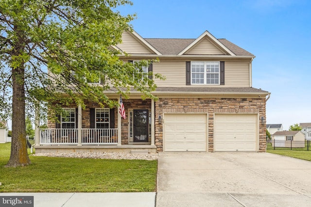 39 Grain Ct, Magnolia, DE 19962 - view of front facade featuring covered porch, a garage, concrete driveway, stone siding, and roof with shingles