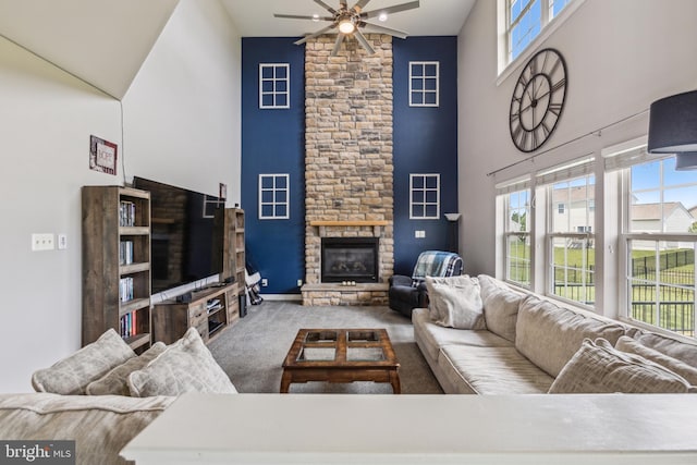 39 Grain Ct, Magnolia, DE 19962 - carpeted living room featuring high vaulted ceiling, a ceiling fan, a stone fireplace, and baseboards
