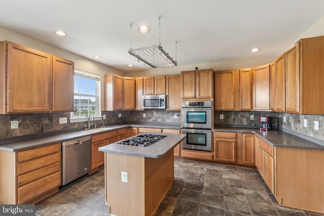 39 Grain Ct, Magnolia, DE 19962 - kitchen featuring appliances with stainless steel finishes, a sink, tasteful backsplash, recessed lighting, and a center island