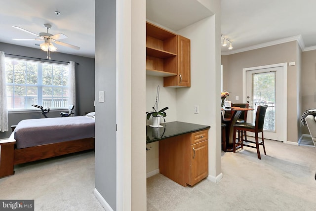 12900 Centre Park Cir Unit 107, Herndon, VA 20171 - kitchen with light carpet, ceiling fan, crown molding, brown cabinets, and dark countertops