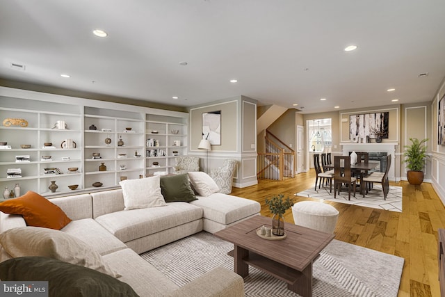 2110 Potomac Ave Unit 102, Alexandria, VA 22301 - living area featuring recessed lighting, light wood-style flooring, stairway, and a decorative wall