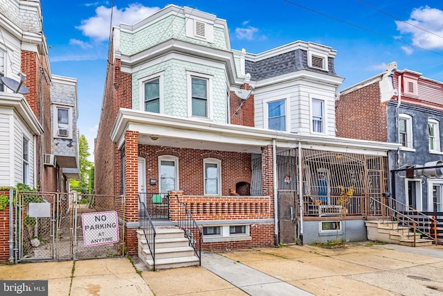 1707 W 4th St, Wilmington, DE 19805 - view of front facade featuring brick siding, a gate, and a porch