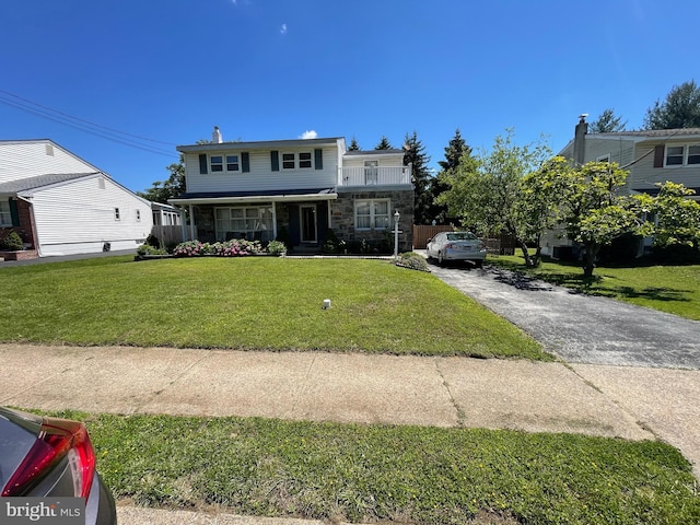 333 Sussex Blvd, Broomall, PA 19008 - traditional home with stone siding, a front lawn, and asphalt driveway