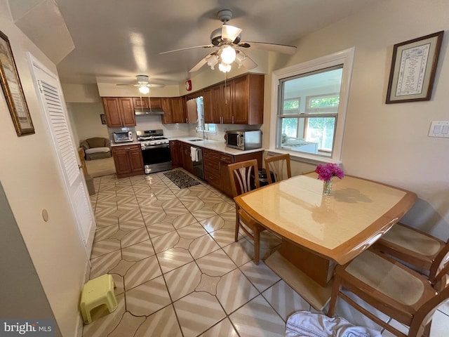 333 Sussex Blvd, Broomall, PA 19008 - kitchen featuring appliances with stainless steel finishes, light countertops, ceiling fan, under cabinet range hood, and a sink