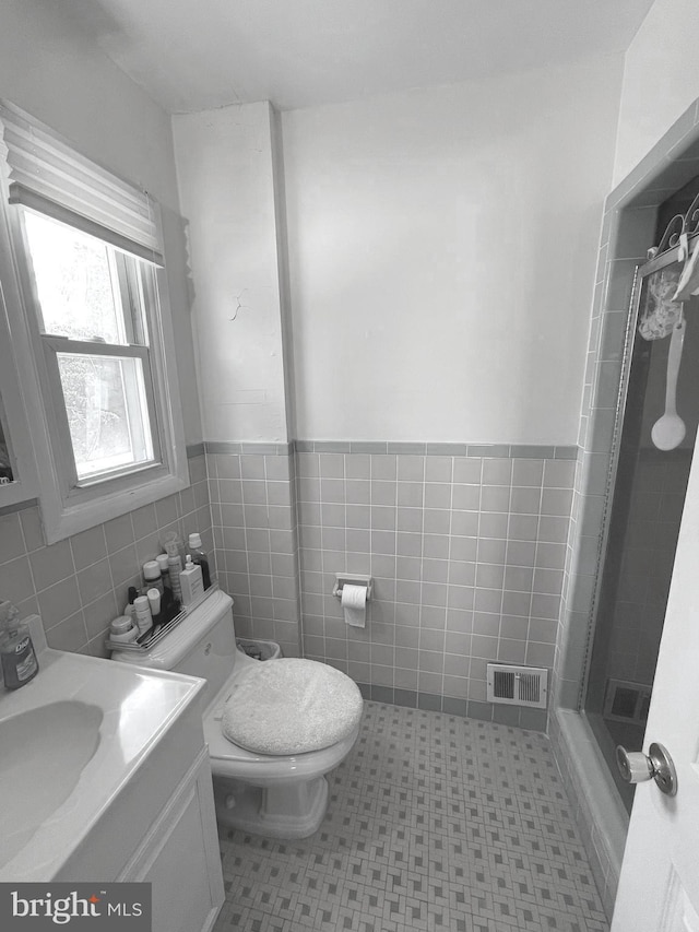 333 Sussex Blvd, Broomall, PA 19008 - full bath featuring a shower stall, toilet, vanity, tile walls, and a wainscoted wall