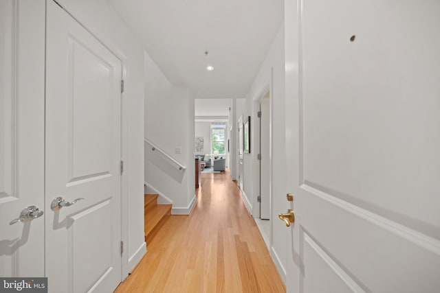 2425 L St NW Unit 328, Washington, DC 20037 - corridor with light wood finished floors, baseboards, stairs, and recessed lighting