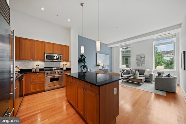 2425 L St NW Unit 328, Washington, DC 20037 - kitchen with high end appliances, light wood finished floors, brown cabinetry, backsplash, and recessed lighting