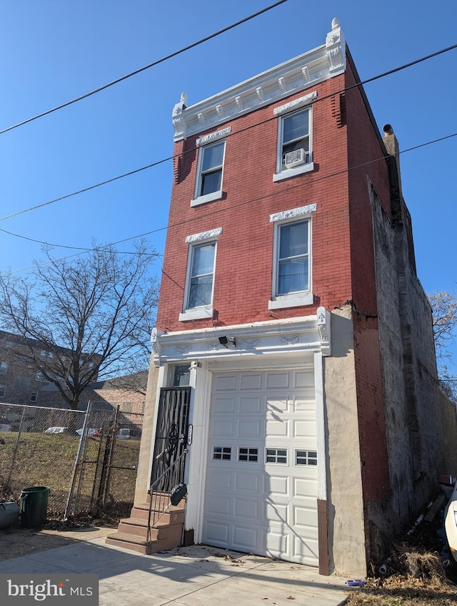 3228 N Sydenham St, Philadelphia, PA 19134 - view of front of house with a garage, brick siding, and cooling unit