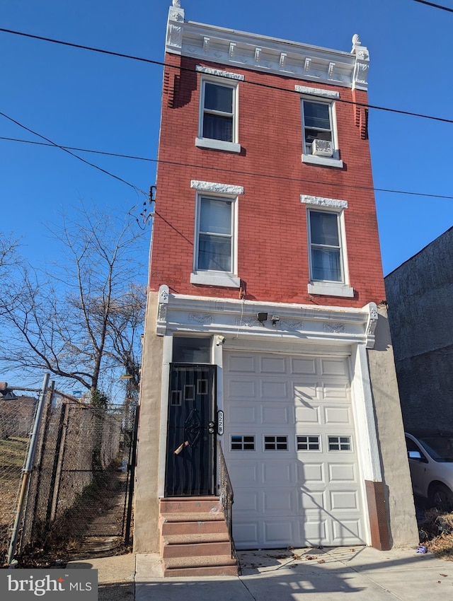 3228 N Sydenham St, Philadelphia, PA 19134 - view of front of house with brick siding, an attached garage, and entry steps