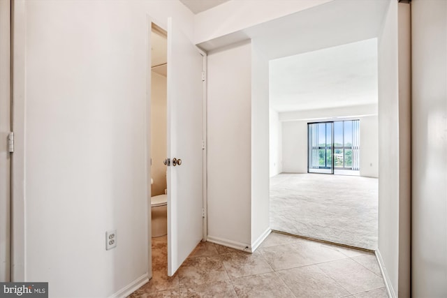 3330 N Leisure World Blvd Unit 5-722, Silver Spring, MD 20906 - hallway featuring light colored carpet, light tile patterned floors, and baseboards