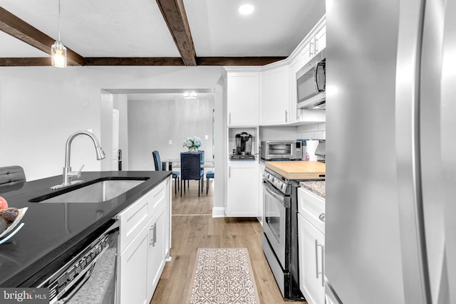 204 Kuethe Rd NE, Glen Burnie, MD 21060 - kitchen featuring appliances with stainless steel finishes, a sink, beam ceiling, light wood finished floors, and white cabinets
