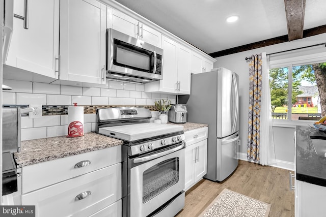204 Kuethe Rd NE, Glen Burnie, MD 21060 - kitchen featuring stainless steel appliances, tasteful backsplash, light wood-style flooring, white cabinets, and beamed ceiling