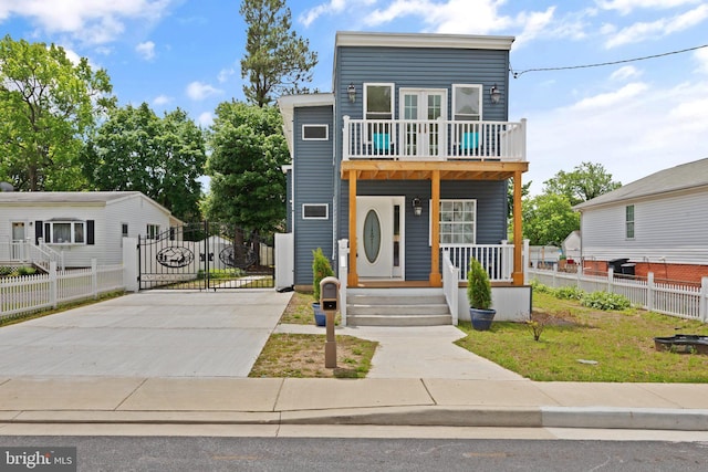 345 Townsend Rd, Essex, MD 21221 - view of front of home featuring a porch, driveway, a balcony, and a gate