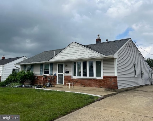 3755 Morrow Dr, Bensalem, PA 19020 - bungalow featuring brick siding, a front yard, a shingled roof, and a chimney