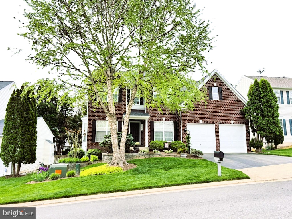 5425 Balls Bluff Ct, Woodbridge, VA 22193 - view of front of house featuring concrete driveway, brick siding, a front lawn, and a garage
