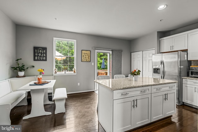 7250 Calm Sunset, Columbia, MD 21046 - kitchen with stainless steel fridge, dark wood finished floors, a center island, white cabinets, and recessed lighting