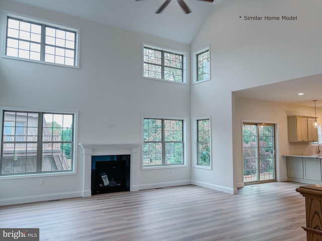 LOT32 Helens Dr, Greencastle, PA 17225 - unfurnished living room with a high ceiling, ceiling fan, light wood-type flooring, baseboards, and a fireplace