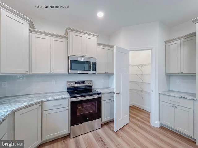 LOT32 Helens Dr, Greencastle, PA 17225 - kitchen featuring appliances with stainless steel finishes, light wood finished floors, light stone counters, and recessed lighting