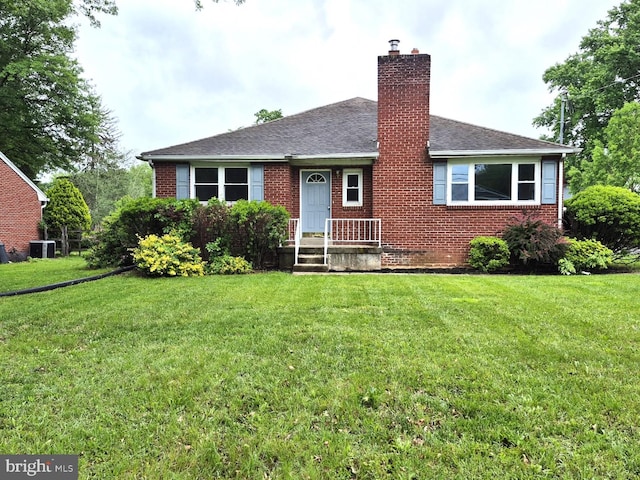 912 Main St, Royersford, PA 19468 - view of front of home with brick siding, a chimney, a front yard, and cooling unit