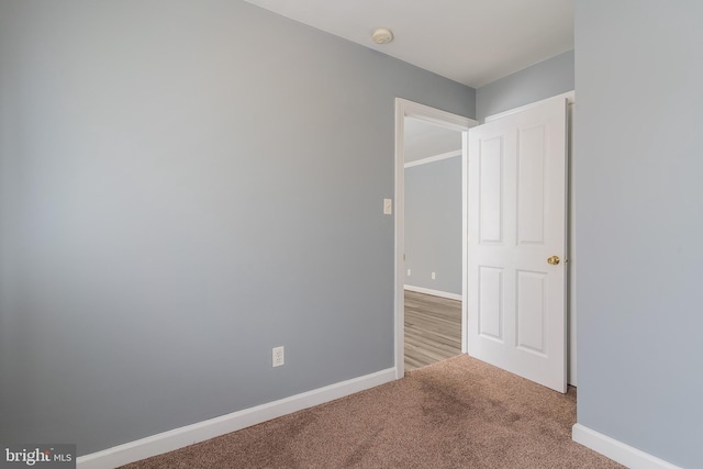721 Brandywine St SE Unit 103, Washington, DC 20032 - carpeted empty room with a smoke detector and baseboards