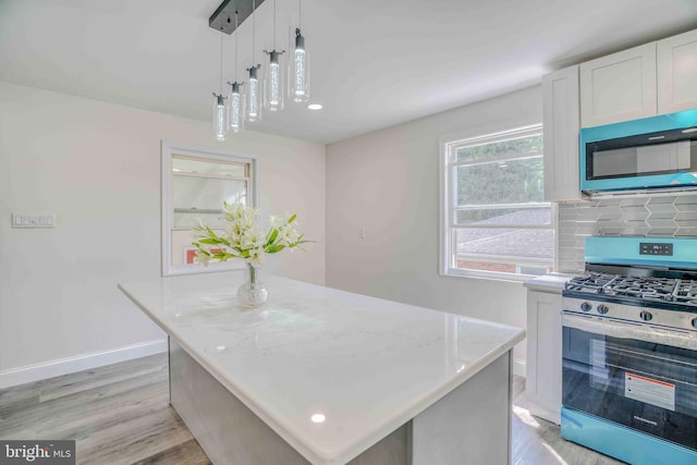 611 Parkview Blvd, Lansdowne, PA 19050 - kitchen featuring appliances with stainless steel finishes, light wood-style floors, a kitchen island, and backsplash