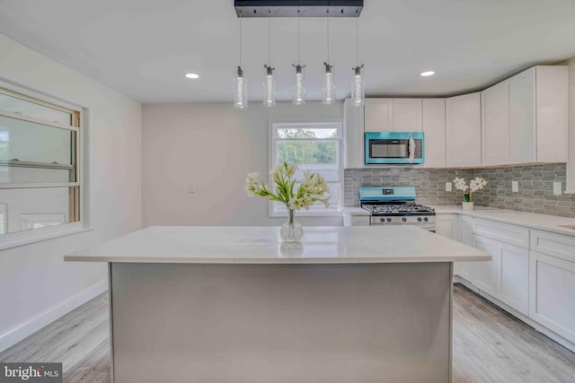 611 Parkview Blvd, Lansdowne, PA 19050 - kitchen featuring appliances with stainless steel finishes, light wood-style floors, tasteful backsplash, a kitchen island, and recessed lighting