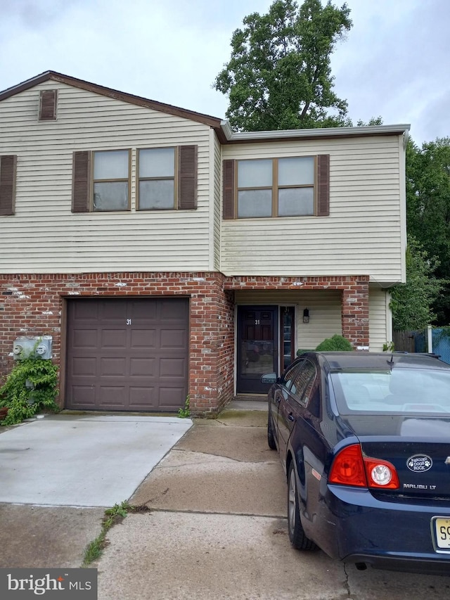 31 Phoenix Ct, Sewell, NJ 08080 - view of front facade with brick siding, an attached garage, and concrete driveway
