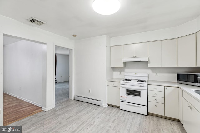 3 Karok Ln, Browns Mills, NJ 08015 - kitchen with white gas range, baseboard heating, stainless steel microwave, light countertops, and light wood-style flooring