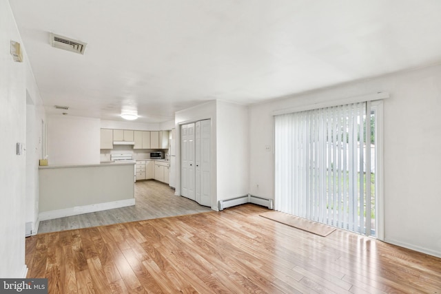 3 Karok Ln, Browns Mills, NJ 08015 - unfurnished living room featuring light wood-style flooring, a baseboard heating unit, and baseboards