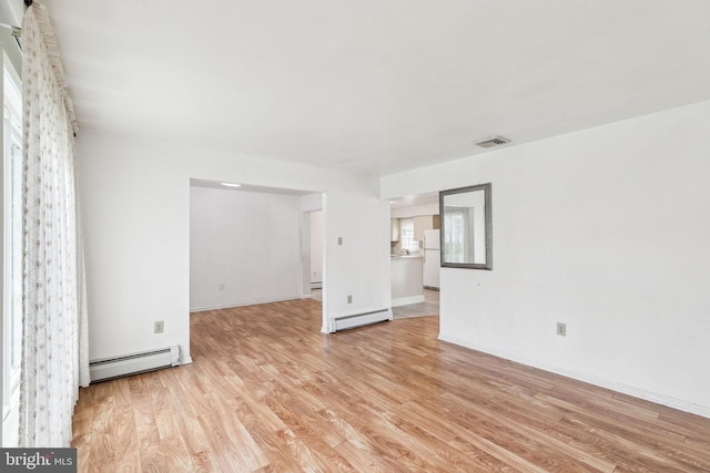 3 Karok Ln, Browns Mills, NJ 08015 - empty room with baseboard heating, a baseboard heating unit, light wood-style flooring, and baseboards