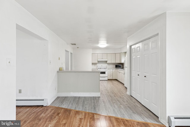 3 Karok Ln, Browns Mills, NJ 08015 - kitchen featuring white appliances, a baseboard heating unit, baseboard heating, light countertops, and light wood-style flooring