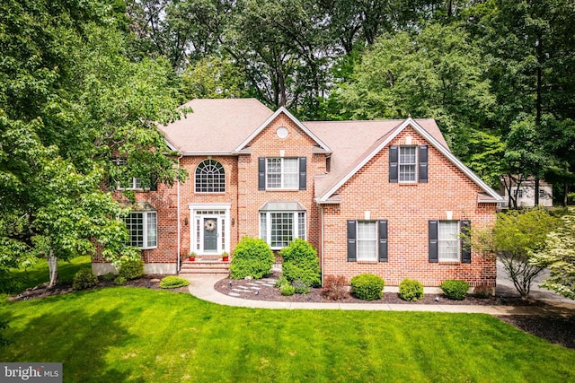 1597 Woodfield Dr, Bethlehem, PA 18015 - colonial-style house featuring a front yard and brick siding