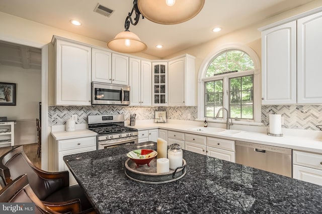 1597 Woodfield Dr, Bethlehem, PA 18015 - kitchen featuring appliances with stainless steel finishes, a sink, a breakfast bar, white cabinets, and decorative backsplash