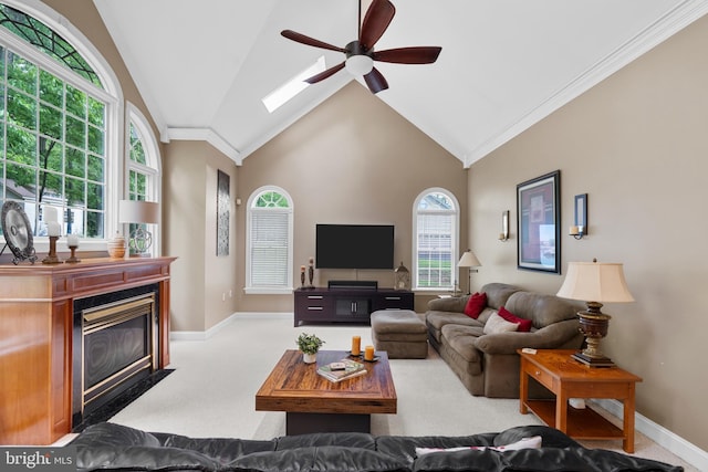 1597 Woodfield Dr, Bethlehem, PA 18015 - carpeted living area with ceiling fan, baseboards, a fireplace with flush hearth, crown molding, and a skylight