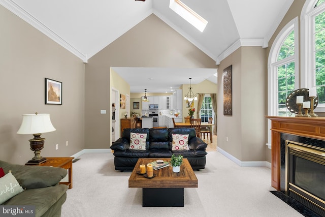 1597 Woodfield Dr, Bethlehem, PA 18015 - living room with light colored carpet, vaulted ceiling, a premium fireplace, ornamental molding, and a chandelier