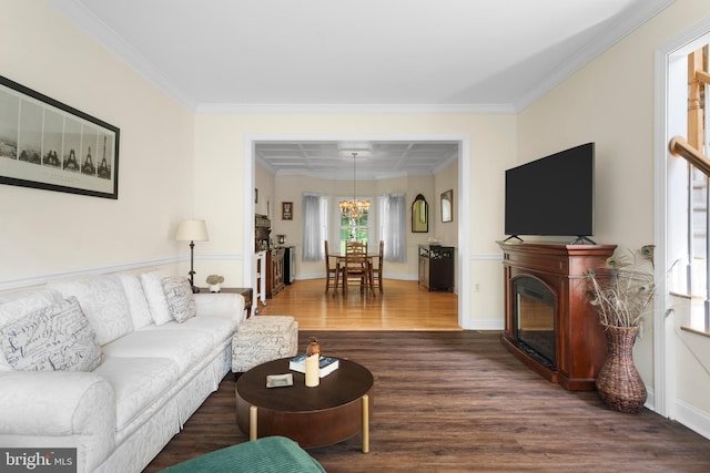 1597 Woodfield Dr, Bethlehem, PA 18015 - living room with dark wood-style flooring, crown molding, a chandelier, a glass covered fireplace, and baseboards
