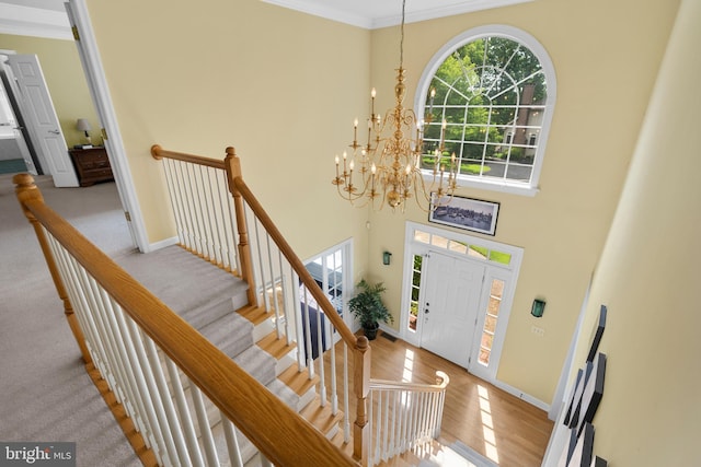 1597 Woodfield Dr, Bethlehem, PA 18015 - entrance foyer featuring a chandelier, baseboards, ornamental molding, wood finished floors, and a high ceiling