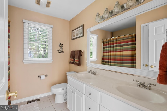 1597 Woodfield Dr, Bethlehem, PA 18015 - full bathroom featuring healthy amount of natural light, toilet, tile patterned flooring, and double vanity