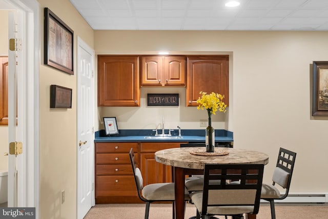 1597 Woodfield Dr, Bethlehem, PA 18015 - kitchen with a baseboard heating unit, brown cabinets, a sink, and light colored carpet