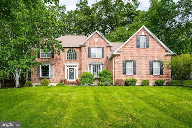 1597 Woodfield Dr, Bethlehem, PA 18015 - colonial inspired home featuring a front yard and brick siding