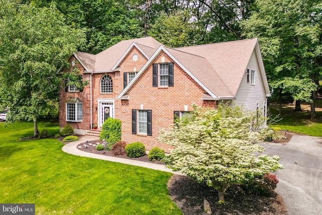 1597 Woodfield Dr, Bethlehem, PA 18015 - view of front of property featuring a front lawn, brick siding, and roof with shingles