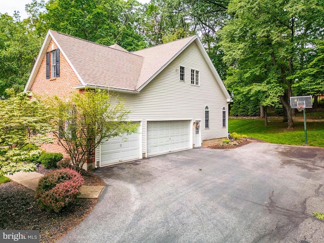 1597 Woodfield Dr, Bethlehem, PA 18015 - view of home's exterior with a shingled roof, driveway, and view of wooded area